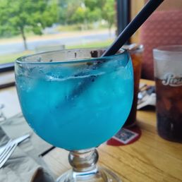 a blue drink in a glass