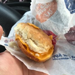 a person holding a sandwich in their hand