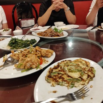 Golden Island Restaurant - a group of people sitting at a table with plates of food - Chinese Near Me - Calgary, Alberta Golden Island Restaurant - a group of people sitting at a table with plates of food - Chinese Near Me - Calgary, Alberta