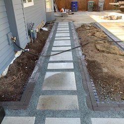 Vision Hardscape Solutions and Landscaping - New stepping stone path with border to the customers front entry.
