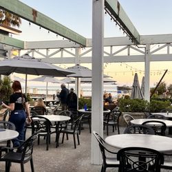 Lovely patio on the side with a fire pit as well as tables in front