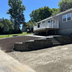 Shine Bros Exterior Services - A retaining wall walk way with new loam installed for grass