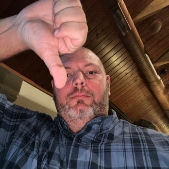 The Cowboy Bar - a man holding his thumb up - Sports Bars Near Me - Buffalo, New York