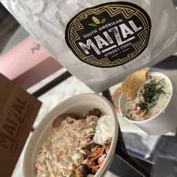 a bowl of food and a bag of chips
