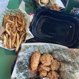 two trays of fried chicken and french fries