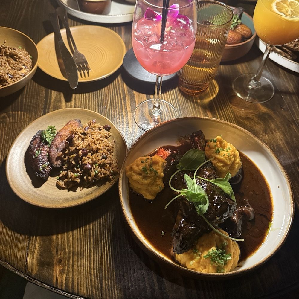 Mango Bay - Lamb shank Sweet Plantain Rice & Peas Truffle Aioli Burger - Caribbean Near Me - Brooklyn, New York Mango Bay - Lamb shank Sweet Plantain Rice & Peas Truffle Aioli Burger - Caribbean Near Me - Brooklyn, New York