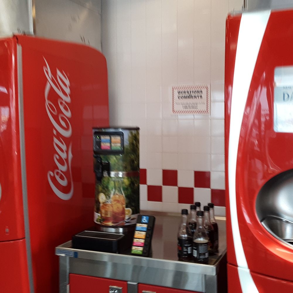 a row of coca cola machines a row of coca cola machines