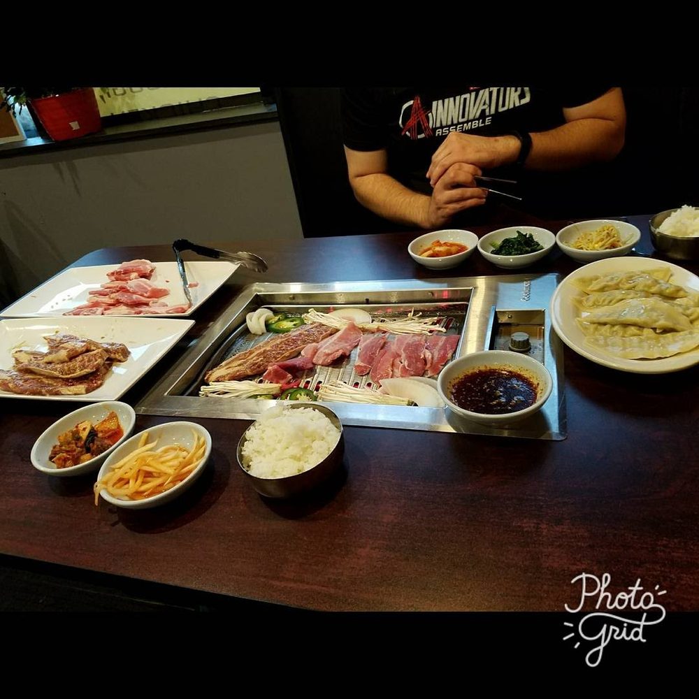 Emonae Korean BBQ - AYCE, with appetizer of steamed dumplings on the right center side. You get little side dishes, usually pickled vegetables. - Korean Near Me - Grand Rapids, Michigan