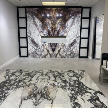Global Stone Marble & Granite - Walking in the showroom waiting area Fireplace marble Calacatta Lilac & floor in porcelain in Calacatta Viola. - Kitchen & Bath Near Me - Commack, New York Global Stone Marble & Granite - Walking in the showroom waiting area Fireplace marble Calacatta Lilac & floor in porcelain in Calacatta Viola. - Kitchen & Bath Near Me - Commack, New York