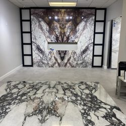 Global Stone Marble & Granite - Walking in the showroom waiting area Fireplace marble Calacatta Lilac & floor in porcelain in Calacatta Viola.