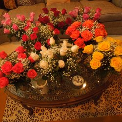 Allen's Florist - Eight vases with 10 roses. Eight different colors.