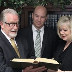 Partridge & Associate CPA's - A shot of the team as they stand together reviewing a segment of tax code