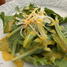 Small salad with papaya dressing that accompanies the omelette rice dish. Small salad with papaya dressing that accompanies the omelette rice dish.