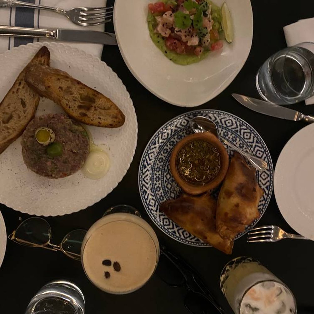 Leña Restaurante - Susana's Gaucho Empanadas (bottom right), Beef Tartare (middle left), Albacore Tune Crudo (top right) - Latin American Near Me - Toronto, Ontario Leña Restaurante - Susana's Gaucho Empanadas (bottom right), Beef Tartare (middle left), Albacore Tune Crudo (top right) - Latin American Near Me - Toronto, Ontario