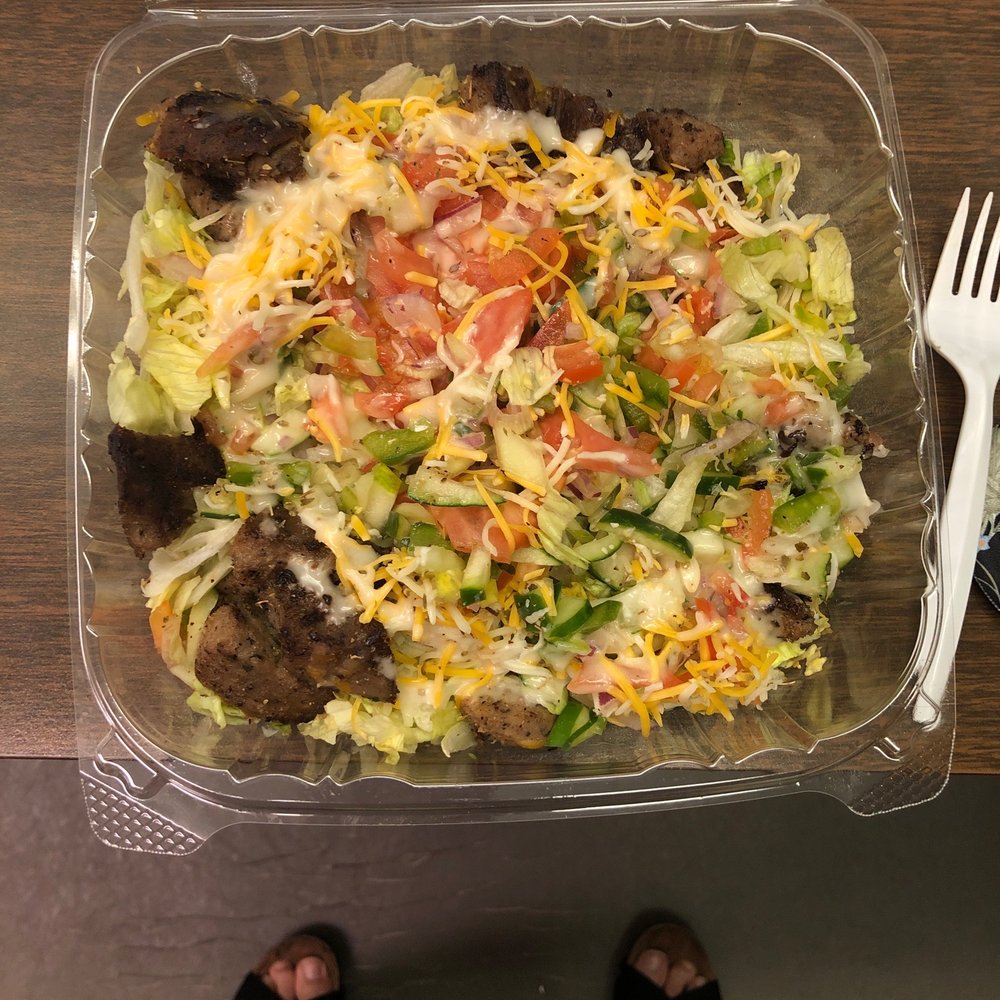 a person standing in front of a salad a person standing in front of a salad
