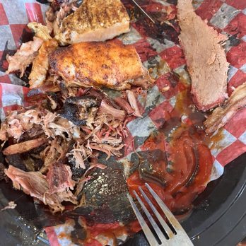 South Moon BBQ - The Chuck Norris on a platter. We were hungry forgot to take a picture. This is the end result, lol. - A barbecue platter with shredded smoked meats, a piece of grilled chicken, and slices of roast beef, served on checkered paper with barbecue sauces. - Barbeque Near Me - Hinckley, Illinois
