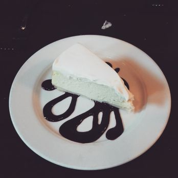 The Rendezvous Grill - Cheesecake with berry sauce and sour cream topping. - New American Near Me - Welches, Oregon