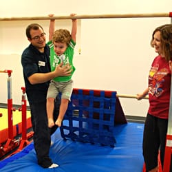 Champaign Gymnastics Academy - Ian assists a young gymnast in the Toddler 2 class.