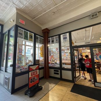 Rocket Fizz - The image shows the entrance to Rocket Fizz, a candy and soda shop, with customers inside browsing shelves of treats and collectibles. - Candy Stores Near Me - Ann Arbor, Michigan