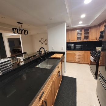 Mereekh Construction - a kitchen with black countertops - General Contractors Near Me
