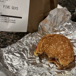 Single Patty Cheeseburger with ketchup mustard and pickels