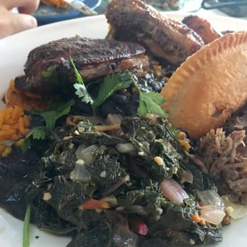 Bahama Breeze - A combo of empanada, roasted chicken, greens, yellow rice, plantain and salsa - Bars Near Me - Troy, Michigan