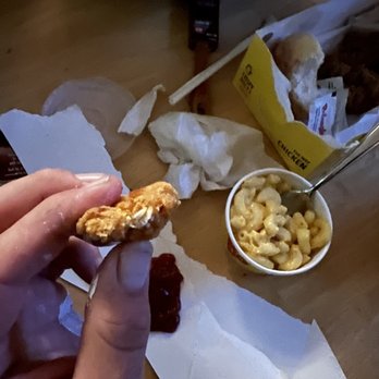 Bojangles - a person holding a piece of food - Fast Food Near Me - Charleston, South Carolina