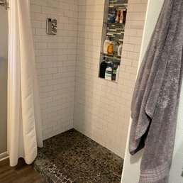 Our shower before. I hated the floor tiles and the ground was uneven, so water pooled.