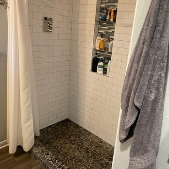 Renovate In Texas - Our shower before. I hated the floor tiles and the ground was uneven, so water pooled. - General Contractors Near Me - Austin, Texas