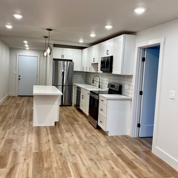 Mircea Ilie Construction - a kitchen with white cabinets and wood floors - General Contractors Near Me - Castro Valley, California Mircea Ilie Construction - a kitchen with white cabinets and wood floors - General Contractors Near Me - Castro Valley, California