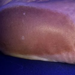 Sun Tan City - Tell me more about the spray tanning booth being sanitized and the caution against putting blocking lotion on the bottom of my feet.