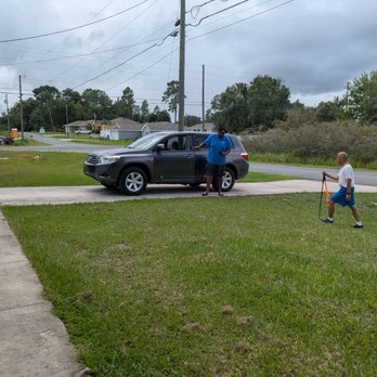 Sell Your Auto Fast - My husband walking up to the driveway to tip the delivery driver. - Used Car Dealers Near Me - Orlando, Florida Sell Your Auto Fast - My husband walking up to the driveway to tip the delivery driver. - Used Car Dealers Near Me - Orlando, Florida