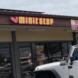 a white jeep parked in front of a store