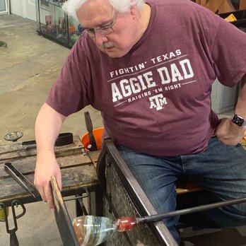 Dallas Glass Art - Using the wooden paddle to flatten the base of the mini vase - Art Galleries Near Me - Dallas, Texas Dallas Glass Art - Using the wooden paddle to flatten the base of the mini vase - Art Galleries Near Me - Dallas, Texas