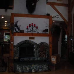 Carriage House Accommodations - Warm up by the riverrock fireplace