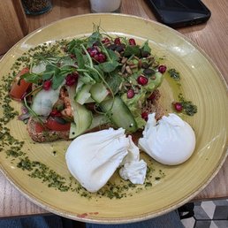 Avocado Smash: brown bread + avocado + pico de gallo + micro greens + pomegranate seeds, poached eggs