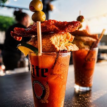 Charlie’s Place - Famous Bloody Mary with Nashville hot chicken biscuit and candied bacon. - Cocktail Bars Near Me - Fort Wayne, Indiana