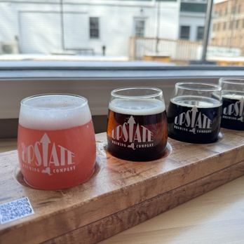 Upstate Brewing - a variety of beers on a wooden tray - Breweries Near Me - Watkins Glen, New York