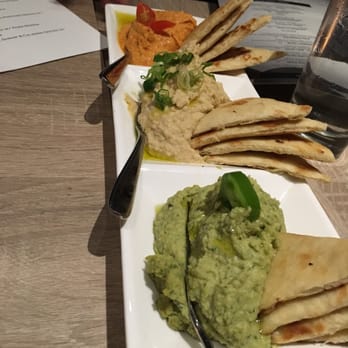 Plateia Mediterranean Kitchen Bar - Hummus trio $10 (traditional, jalapeño cilantro, roasted red pepper) - Bars Near Me - Glenview, Illinois Plateia Mediterranean Kitchen Bar - Hummus trio $10 (traditional, jalapeño cilantro, roasted red pepper) - Bars Near Me - Glenview, Illinois