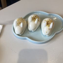 Rabbit shaped coconut jello. Had almond jello consistency. I think crush flowers on top. Yum! Rabbit shaped coconut jello. Had almond jello consistency. I think crush flowers on top. Yum!
