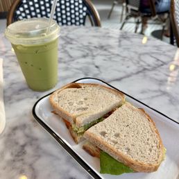 Iced matcha latte with oat milk and BALT sandwich. Iced matcha latte with oat milk and BALT sandwich.