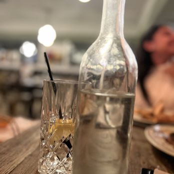 Delucca Gaucho Pizza & Wine - Fort Worth - a bottle of alcohol and a glass of water - Pizza Near Me - Fort Worth, Texas Delucca Gaucho Pizza & Wine - Fort Worth - a bottle of alcohol and a glass of water - Pizza Near Me - Fort Worth, Texas