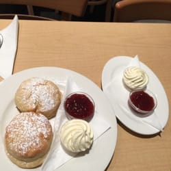 42nd Street Cafe - My scones with jam and cream and the secondary jam and cream I asked for. Notice the size of the scones.