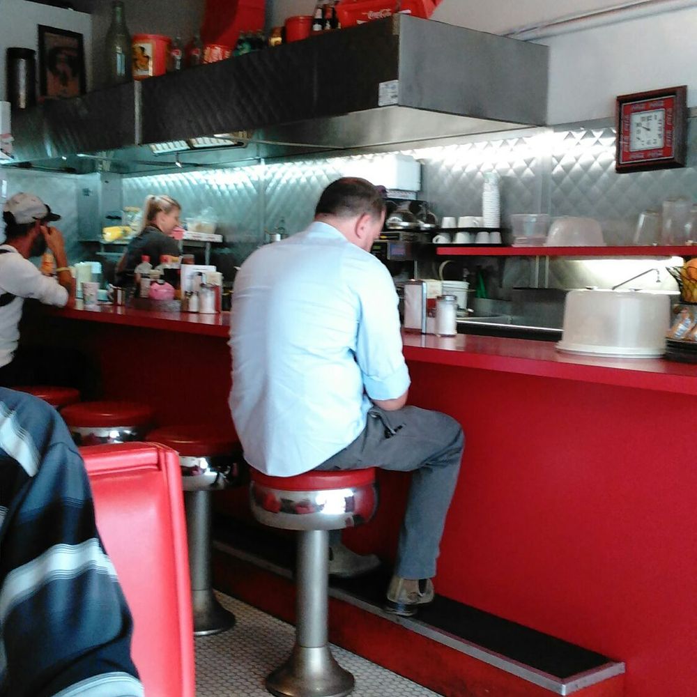a man sitting at the counter a man sitting at the counter