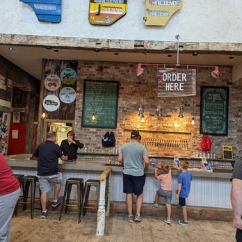 Door County Brewing - a group of people at a bar - Brewpubs Near Me - Baileys Harbor, Wisconsin