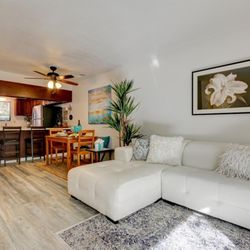 Homes Staged by Candice - We quickly transformed this condo using a chic sectional white leather sofa. It sold in a flash!