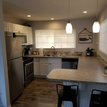 Rebel Renovations - a kitchen with white cabinets and stainless steel appliances - General Contractors Near Me Rebel Renovations - a kitchen with white cabinets and stainless steel appliances - General Contractors Near Me