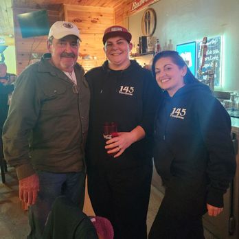 145 Roadhouse - three men and a woman posing for a picture - Sports Bars Near Me - Campton, Kentucky