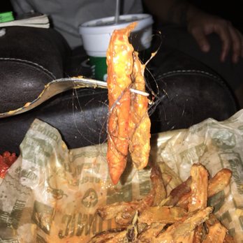 Wingstop - a person holding a fork over a basket of fried shrimp - Chicken Wings Near Me - Mission, Texas