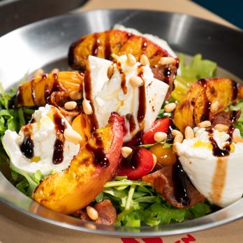 Tripping Animals Brewing - Peachy Burrata Salad: Creamy burrata over arugula with sweet peaches, cherry tomatoes, pine nuts, and a balsamic glaze. - Breweries Near Me - Doral, Florida Tripping Animals Brewing - Peachy Burrata Salad: Creamy burrata over arugula with sweet peaches, cherry tomatoes, pine nuts, and a balsamic glaze. - Breweries Near Me - Doral, Florida